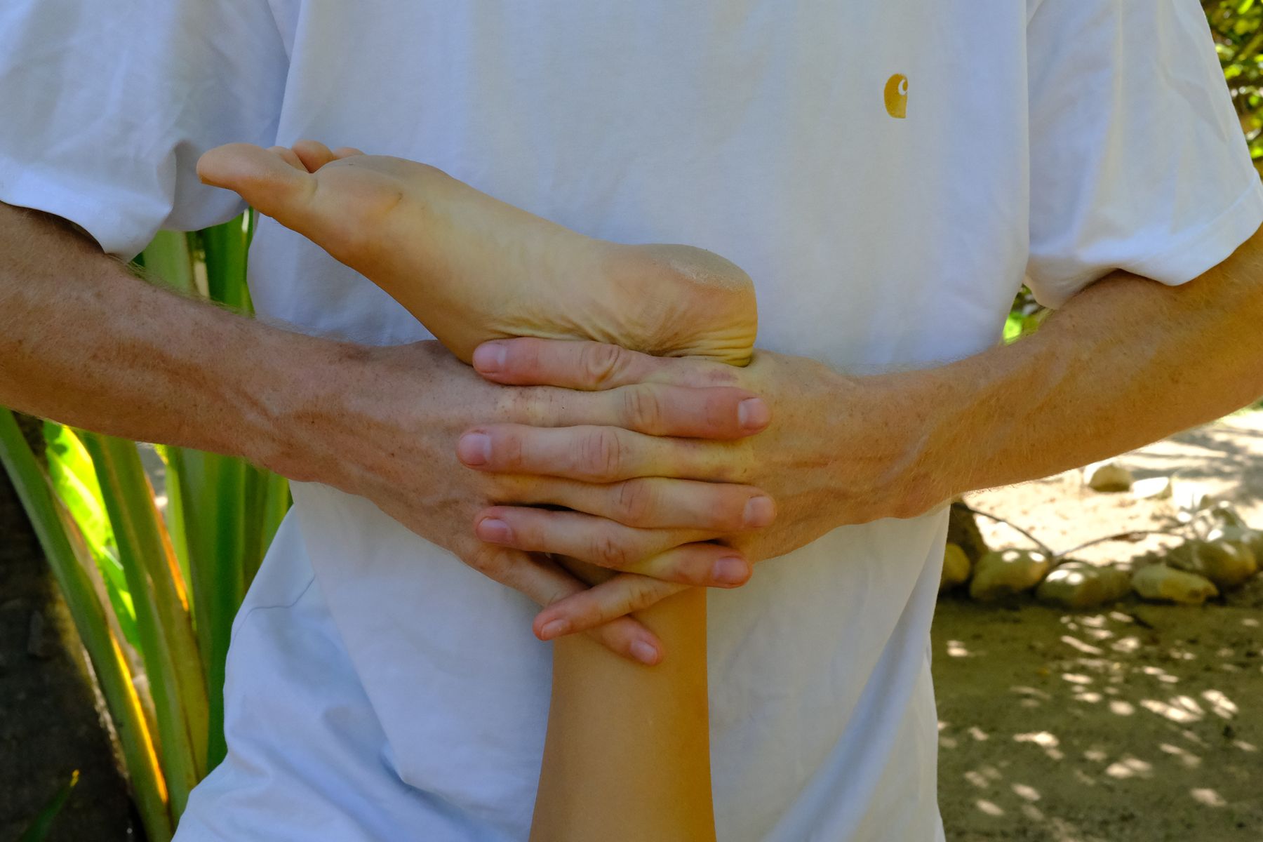 Close-up of Jan's hands mobilizing an ankle